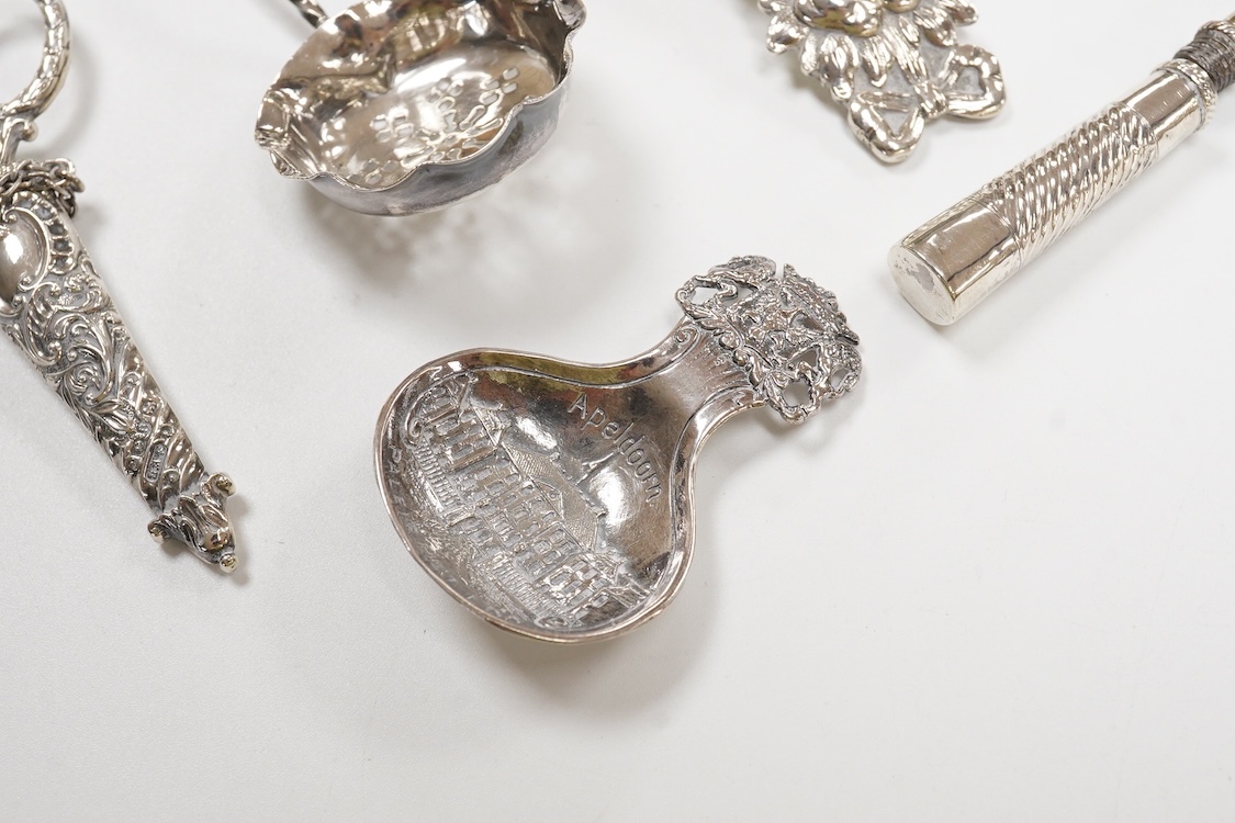 Small silver and white metal, including an Edwardian silver tea strainer, import marks for London, 1908, 15.7cm, a late Victorian silver sifter spoon, silver handled scissors with case, a white metal corkscrew and a whit